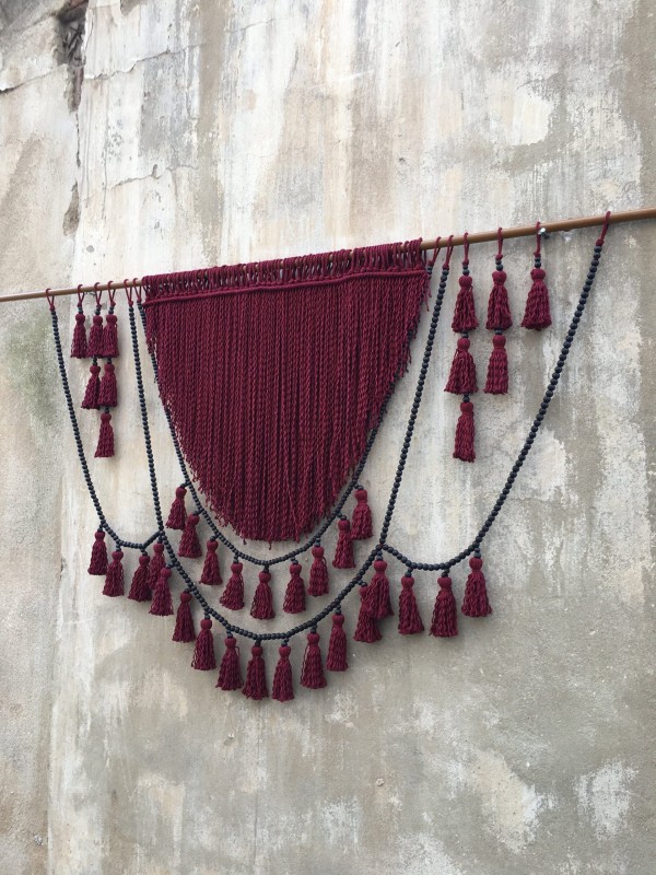 Red macrame headboard with beads