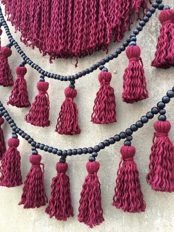 Red macrame headboard with beads