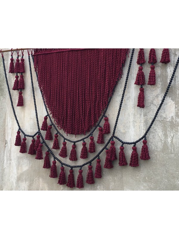 Red macrame headboard with beads